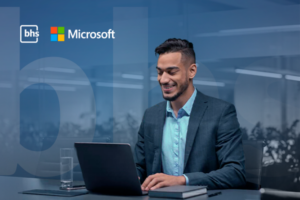 Profissional de TI trabalhando em notebook com as logos da BHS e Microsoft ao fundo, representando a gestão de licenciamento Microsoft 365
